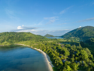 Aerial view of Port Launay Beach in Port Glaud, Mahe, Seychelles with lush greenery and a tranquil coastline.