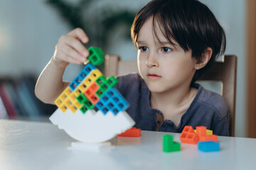 Child playing with a balance board game at home