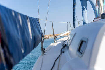Sailing on a sunny day with furled jib and blue sea