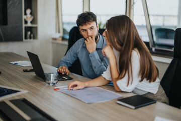 A focused business meeting with diverse people engaging in a thoughtful discussion. The modern...