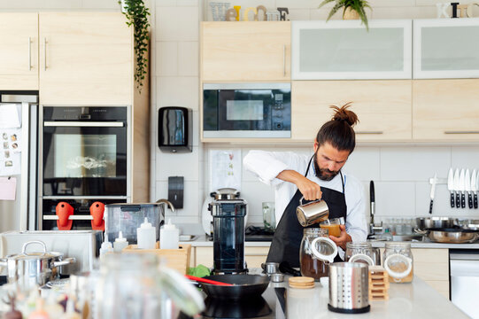 Male chef preparing coffee in kitchen at restaurant