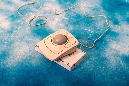 Fototapeta Retro trackball mouse on VHS tape with blue background