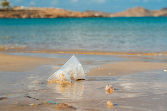 Plastic bag pollution on a beach in Paros island highlighting environmental issues