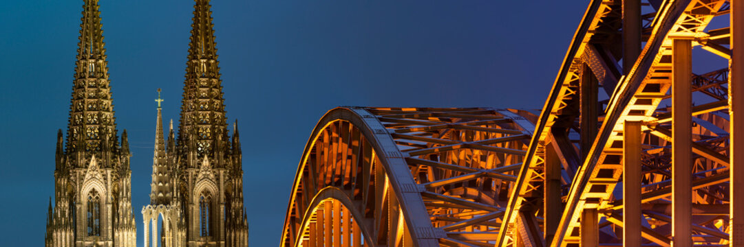 Evening view of Cologne Cathedral and Hohenzollern Bridge in Cologne, Germany with LED lighting - Powered by Adobe