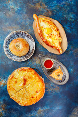Khachapuri with cheese, savory open or closed pie with cheese and egg, traditional Georgian dish from the Caucasus region