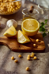 Chickpeas, lemon, tahini and herbs, ingredients for making hummus, close up.
