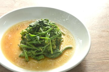 fried Chayote sprout with chili and soybean sauce on plate