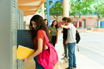 Fototapeta na wymiar Teenage girl being bullied by her classmates at school