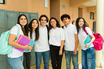 Group of high school students wearing uniform posing by lockers