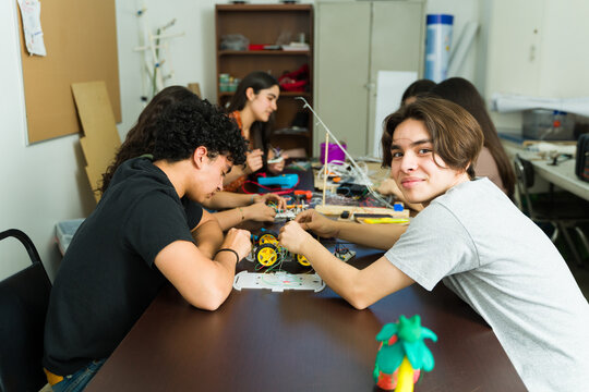 Latin american students building robot in science class