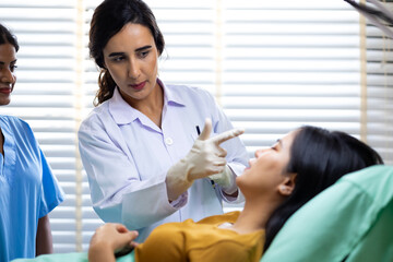 Fototapeta premium Facial aesthetics surgery treatment : Plastic (Cosmetic) Surgery Center : Brazilian hispanic female Doctor preparing Asian female patient for cosmetic surgery in clinic