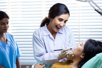 Obraz premium Facial aesthetics surgery treatment : Plastic (Cosmetic) Surgery Center : Brazilian hispanic female Doctor preparing Asian female patient for cosmetic surgery in clinic