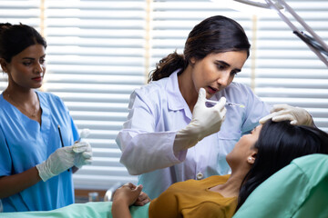 Obraz premium Facial aesthetics surgery treatment : Plastic (Cosmetic) Surgery Center : Brazilian hispanic female Doctor preparing Asian female patient for cosmetic surgery in clinic