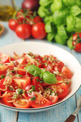 A bowl with Romanian tomato salad de Rosii	