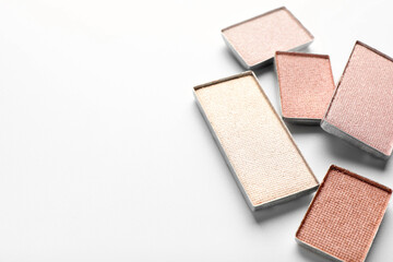 Beautiful eye shadow refill pans on white background, closeup. Space for text