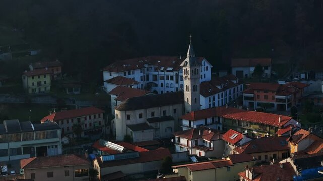 Aerial View Of Church Of Saint Albinus Surrounded By Red-roofed Buildings In Pella, Piedmont, Italy. ascending drone shot
