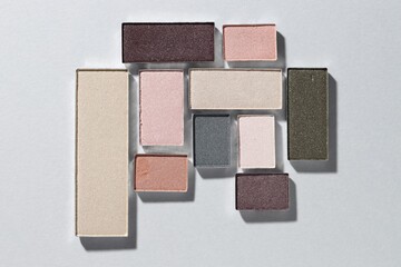 Beautiful eyeshadow refill pans on light background, flat lay