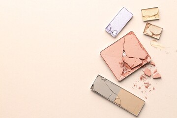 Fototapeta premium Beautiful eyeshadow refill pans on beige background, flat lay. Space for text