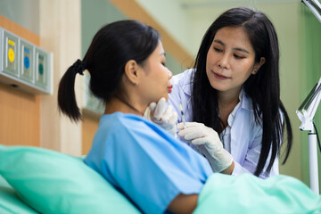 Fototapeta premium Facial aesthetics surgery treatment : Plastic (Cosmetic) Surgery Center : Asian female Doctor preparing female patient for cosmetic surgery in clinic