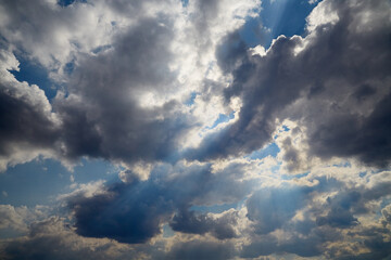 Fototapeta premium The contrasting sky with textured clouds in sunlight can be used as a metaphor for uncertainty and future changes.
