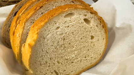 Crusty sourdough slices nestled in linen evoke Lammas rituals, culinary artistry, and homely bakes with golden nostalgia