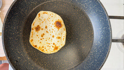 Sizzling solitary roti in a minimalist pan whispers of Diwali feasts and culinary mindfulness journeys, golden nostalgia aroma