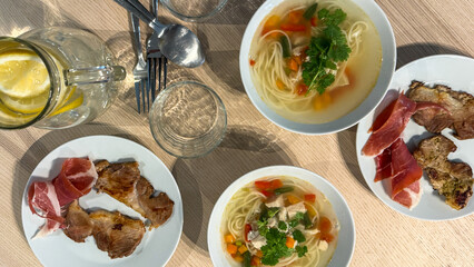 Enticing symphony of vibrant noodle soups and succulent cured meats, evoking Lunar New Year feasts and cozy gastronomic retreats