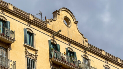 Aged ochre facade basks beneath cotton-clouded skies, whispering tales of Mediterranean Sepulveda Day and Baroque Shadow Festival