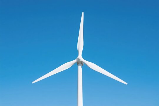 A large white wind turbine against a clear blue sky - Powered by Adobe