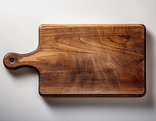 worn wooden cutting board with handle displaying surface texture and scratches on clear backdrop