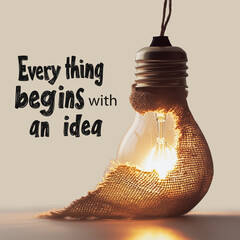 A light bulb is partially covered from below with a burlap sheet, set against a brown background.
