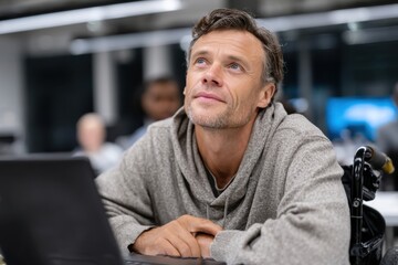 Fototapeta premium A pensive man gazes upward while sitting in a modern office space, symbolizing reflection and creativity. The atmosphere suggests collaboration and innovation.