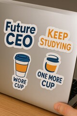 Laptop covered with motivational stickers like Future CEO and Keep Studying