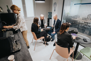 Group of colleagues engaging in conversations during a coffee break, highlighting teamwork and...
