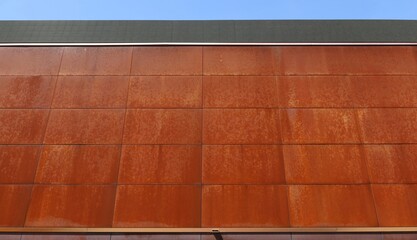 Modern building facade of rusted steel corten plates steel facade. Background and texture.