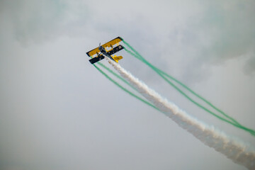 Fototapeta premium Wingwalker Stunt Over the Saudi Desert Aviation Daring at KSA Airshow