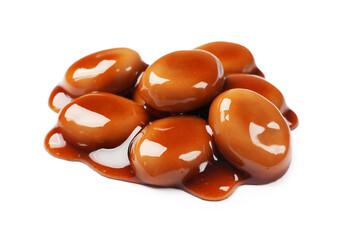 Tasty sweet candies and caramel sauce isolated on white