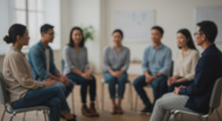 Fototapeta premium Blurred group of individuals engaged in a discussion in a bright, modern office setting during a team-building session