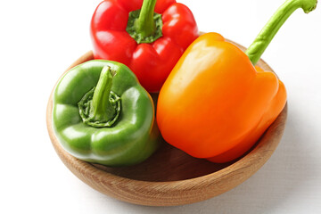 Ripe colorful bell peppers on white table, closeup