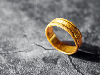gold ring, gold price, gold jewelry, close up of gold ring on grey background