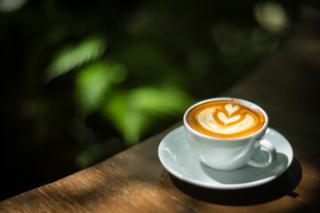 Background Coffee cup and beans on old kitchen table. Hot art Latte Coffee.
