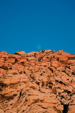 the moon rising over mountains