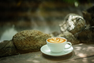 Background Coffee cup and beans on old kitchen table. Hot art Latte Coffee.
