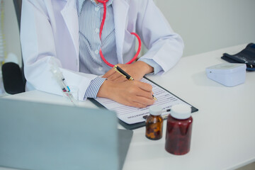 Female doctor gives advice and explains to patient for annual health check in examination room by...
