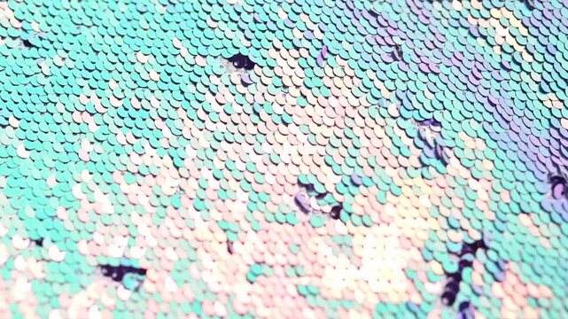 Shimmering turquoise background vibrant, pink and creating sequins textured surface reflecting glamorous party and fashion aesthetics video 4k
