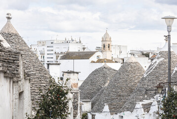 Typical Street in Alberobello, Italy with Iconic Whitewashed Trulli Houses and Cobblestone Path