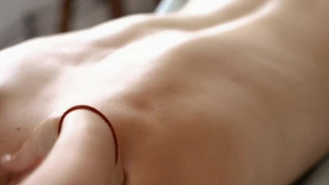hands of a therapist massaging a customer's neck and back at a spa