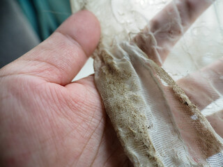 Dirty white curtains with stains inside the house