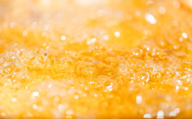 Close up bright orange Oil or beer splash texture and nature waves, Beautiful waves curve and little bubbles smooth for graphic design and background, Oil Bubbles, Soft beer bubbles, Selective focus