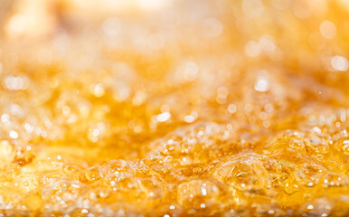 Close up bright orange Oil or beer splash texture and nature waves, Beautiful waves curve and little bubbles smooth for graphic design and background, Oil Bubbles, Soft beer bubbles, Selective focus